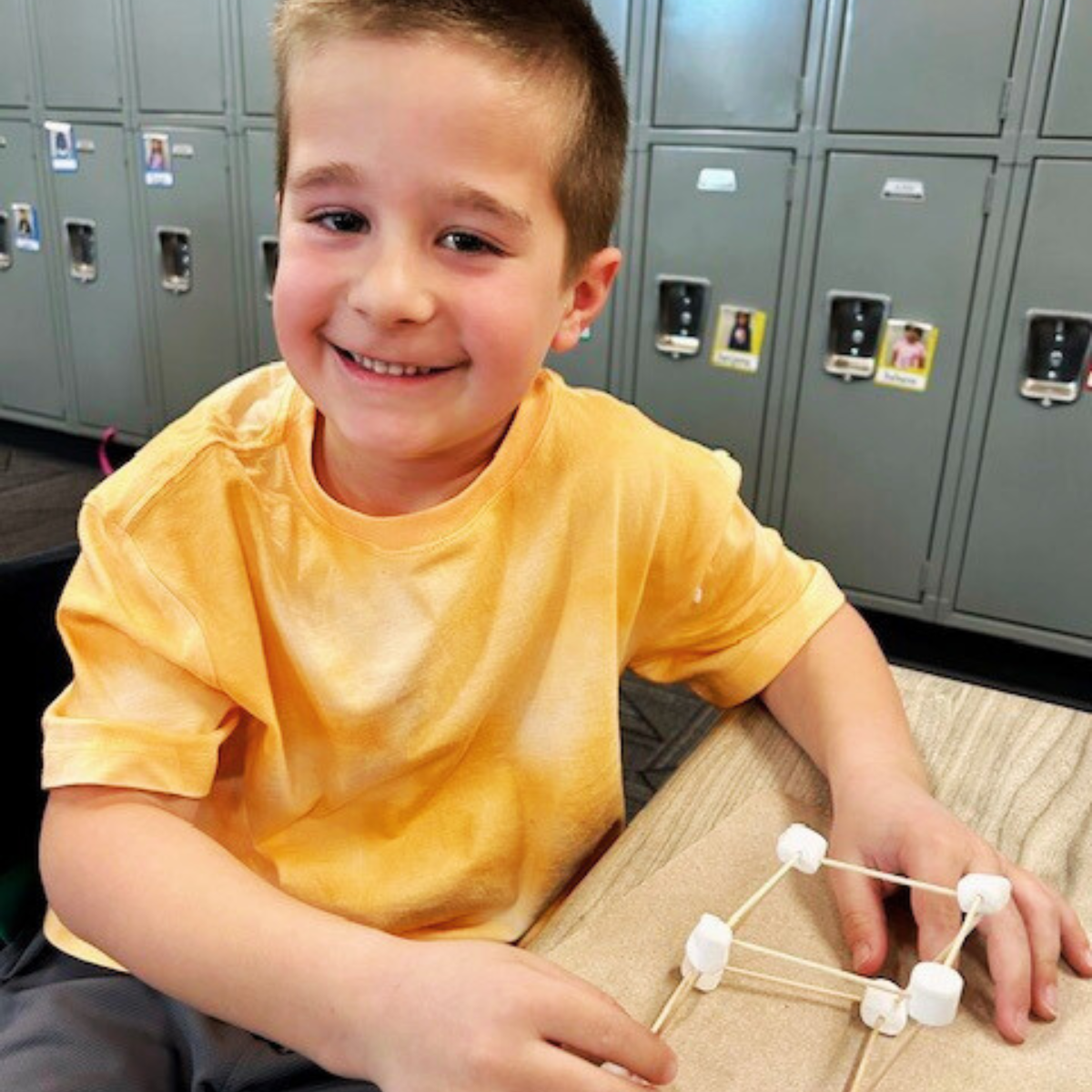 Students show off their 3D models made with marshmallows and noodles.