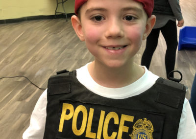 Student trying on police vest