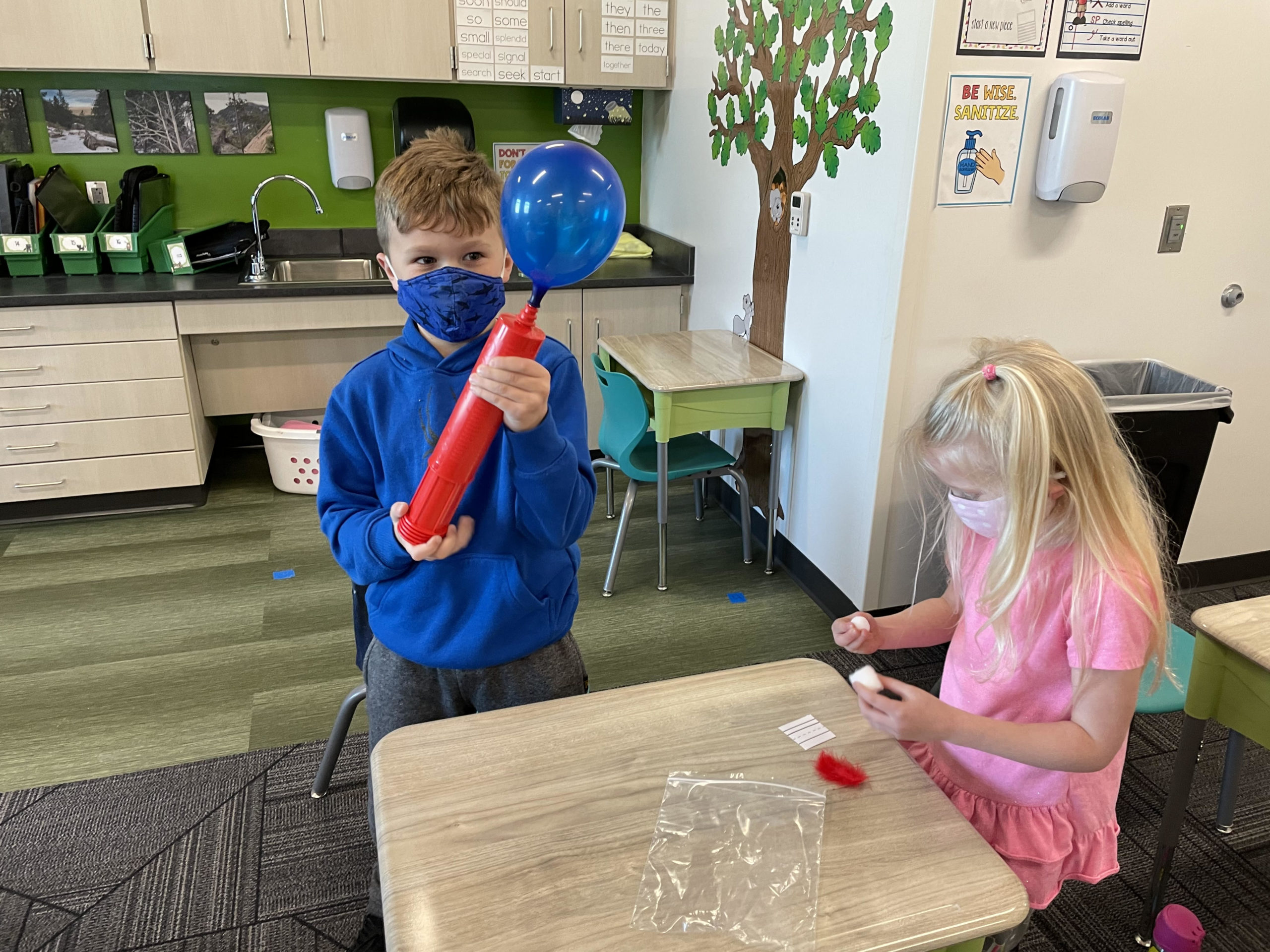 Students showing blown up balloon