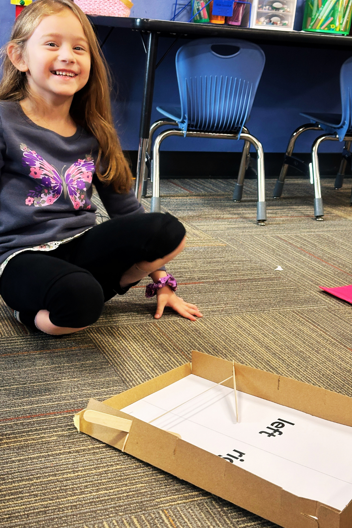 Students use a homemade pinball machine to learn about force.