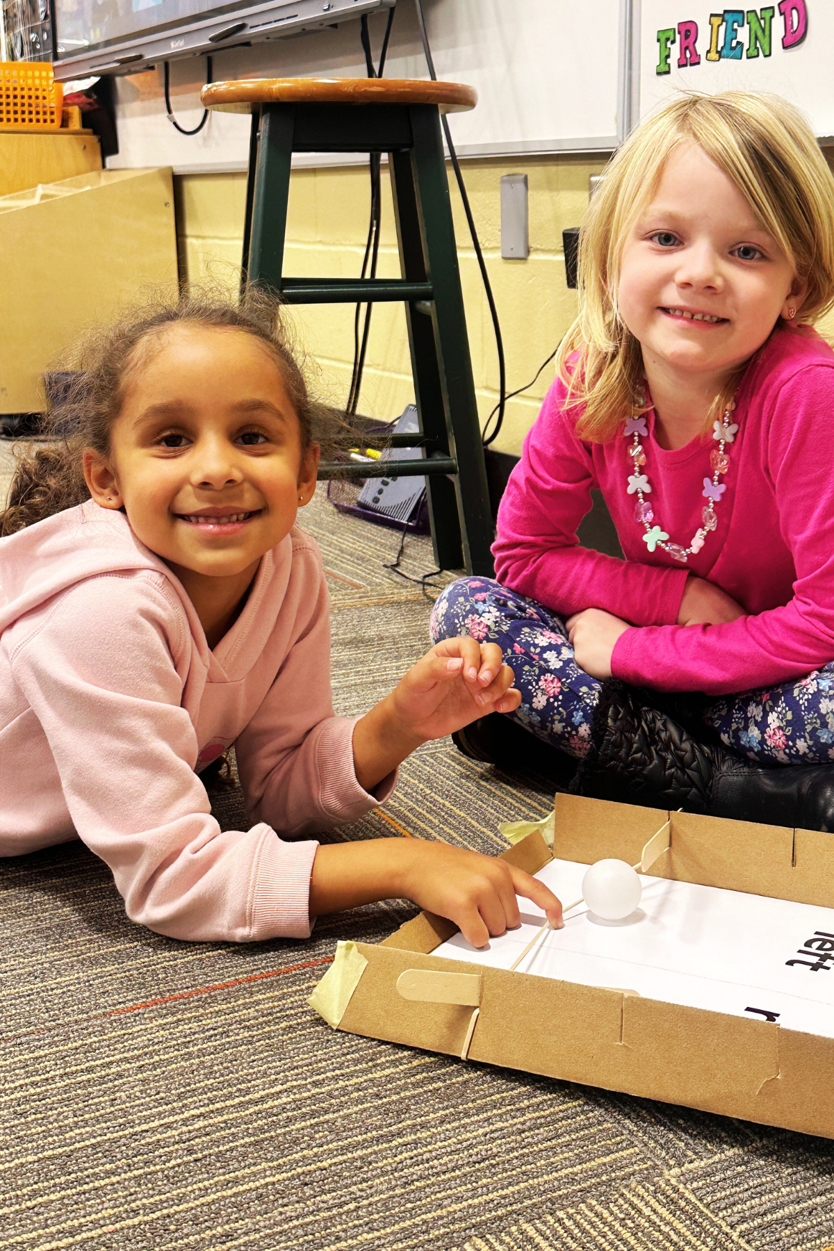 Students use a homemade pinball machine to learn about force.